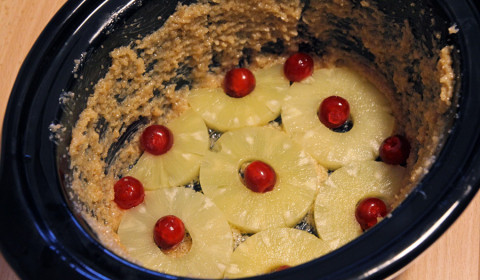 le ciliegie e l'ananas adagiate sul fondo della Slow Cooker
